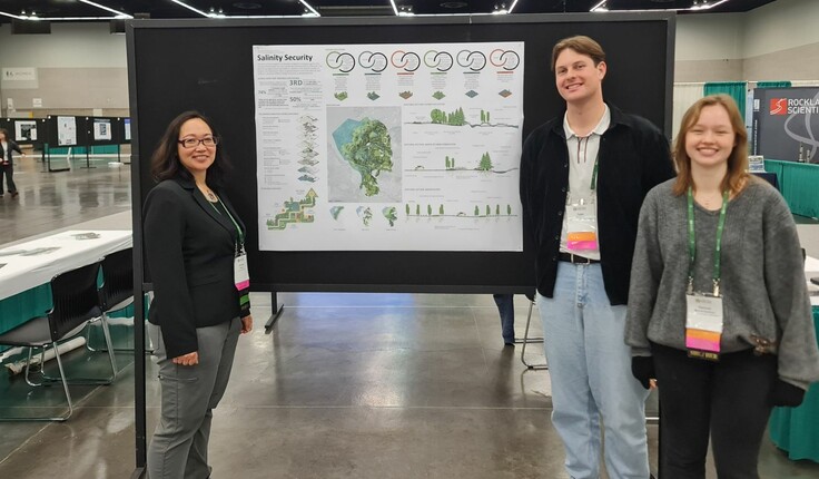 Tyler Florance and Hannah Merrett-Kaufman and Dr Victoria Chanse in front of the submission poster.