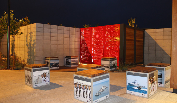 Several cube seats clustered near the entrance. Galvanised steel frames with fixed steel panels and timber tops. The NZ Defence Force provided contemporary Navy images which were laminated to the steel panels by the local Horton Signs.