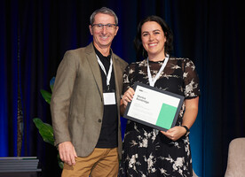 John Potter presenting Monica Bainbridge with her Registration Certificate at the 2022 NZILA Firth Conference welcome function.