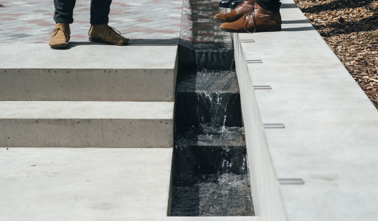 Channel for water to flow after emerging from the ground in a cluster of jets.
