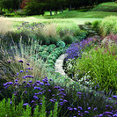 Stepping stones lead to the golf course across the garden.