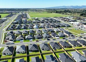 This drone image shows a farm in Rolleston awaiting further suburban conversion, with roads starting and stopping on either side of the farm. Donald Royds, CC BY-SA