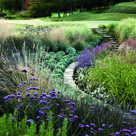 Stepping stones lead to the golf course across the garden.