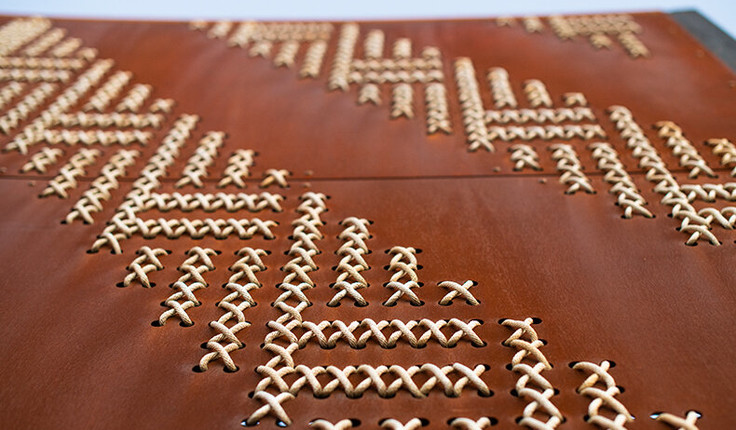 One hundred and twelve steel tukutuku panels, punched with 53,900 individual holes have been woven with 7.3km of cord by volunteers from Ngāti Oneone and DOC, Gisborne District Council and other skilled weavers from around Tairawhiti. Nick Tupara, Ngati Oneone artist and representative, developed the woven designs incorporating patterns kaokao, poutama, roimata tōroa, pātiki and patterns specific to Te Poho o Rāwiri Marae. Creating the panels was a physical challenge because of the sheer size, scale and materials of the tukutuku – steel and rope - compared to the traditional harakeke and slat board.