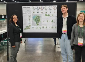 Tyler Florance and Hannah Merrett-Kaufman and Dr Victoria Chanse in front of the submission poster.