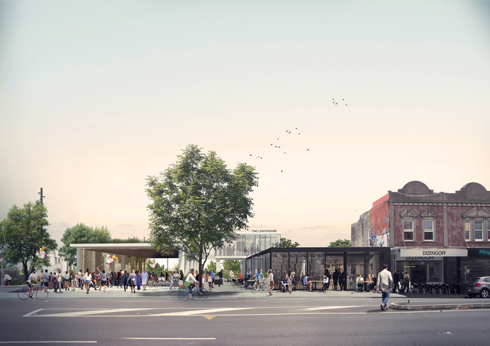 Looking west across Ponsonby Road into the site showing existing buildings retained/adapted to the street edge and green park spaces beyond_